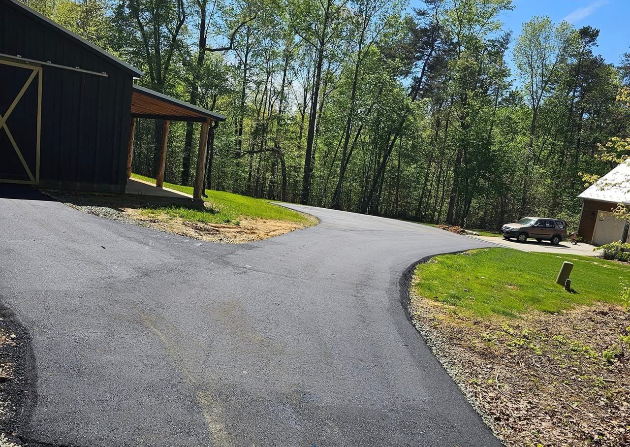 Wide new asphalt driveway and turnaround
